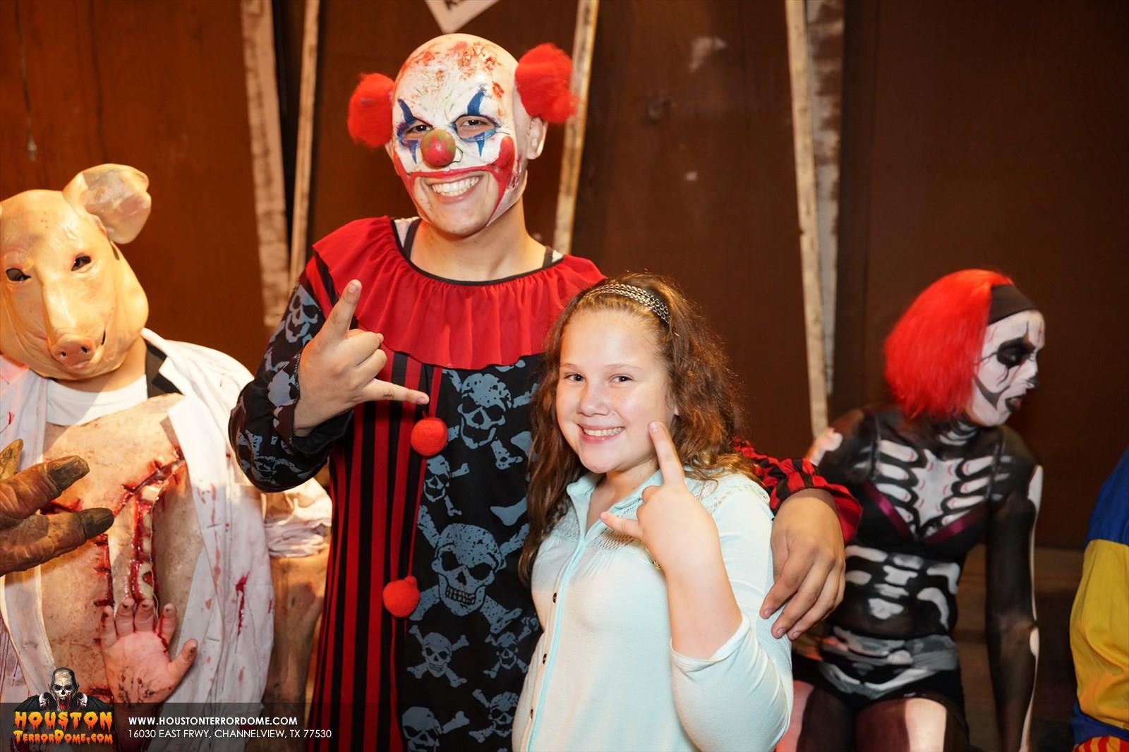 Clown from Haunted House Posses for picture with customer.