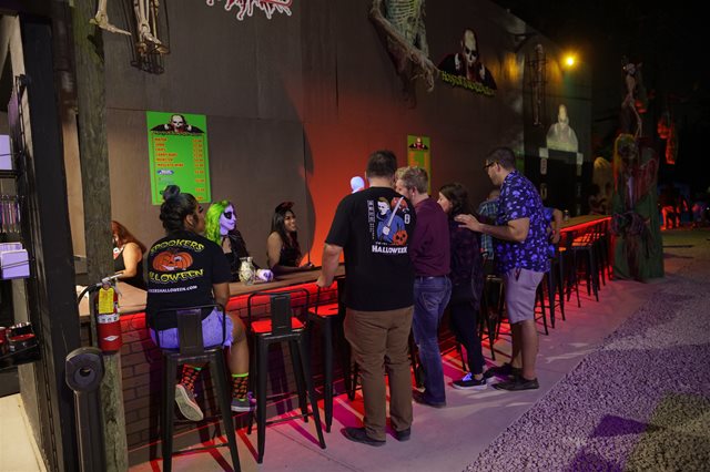 Customers enjoying a seat at the bar in Nightmare Alley